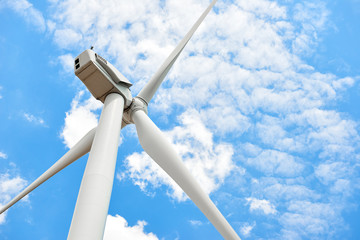 The wind generator is in bright cloudy sky. Eco energy concept.