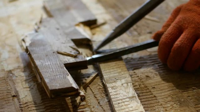 The worker dismantles the parquet floor