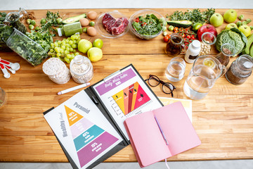 Nutritionists working place with drawings on the topic of healthy eating, empty notebook and...