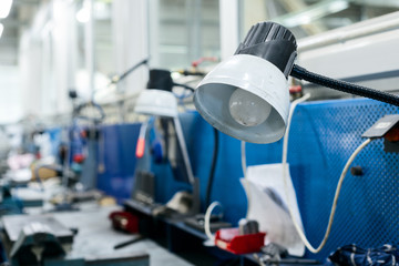 Locksmith, rows of table lamps are installed above the table