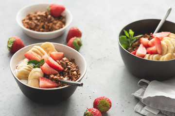 Fruits with granola and yogurt in bowl for breakfast. Morning light. Concept of healthy eating, healthy lifestyle