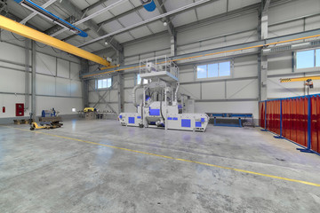 Obraz premium Interior of a modern factory. A bright large workshop, inside there is a shot blasting unit