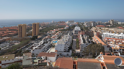 Elevated views of Los Cristianos and Las Americas from Montana Chayofita, popular for shopping, entertainment venues, eateries and restaurants, accessible beaches, in Tenerife, Canary Islands, Spain