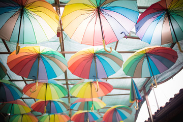 Fototapeta na wymiar Colorful umbrellas background. Colorful umbrellas in the sky
