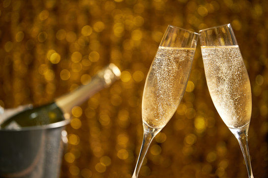 Glasses of champagne on a golden background, party or holiday concept