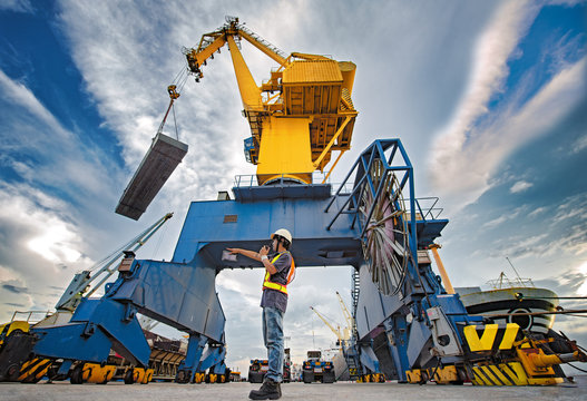 stevedore foreman and or supervisor, loading master takes control in loading discharging operation by walkie talkie and device on line, port operation working under control at quayside