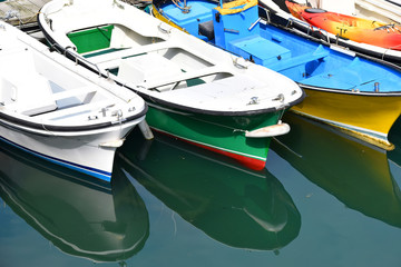 Fototapeta na wymiar green and yellow white boat moored in the harbor