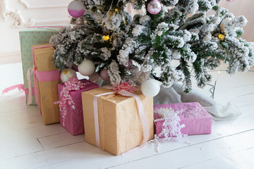 gifts under the Christmas tree in a beautiful house