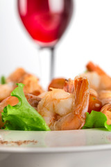 close-up of salad with king prawns on a plate on a light background