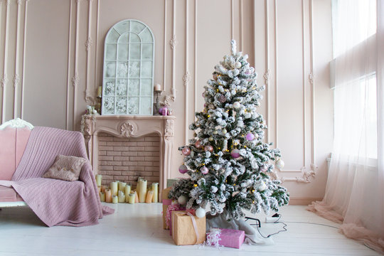 Beautiful winter interior in the photo studio. Bed Christmas tree and fireplace