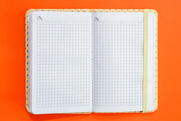 Top view open notebook on orange colorful background