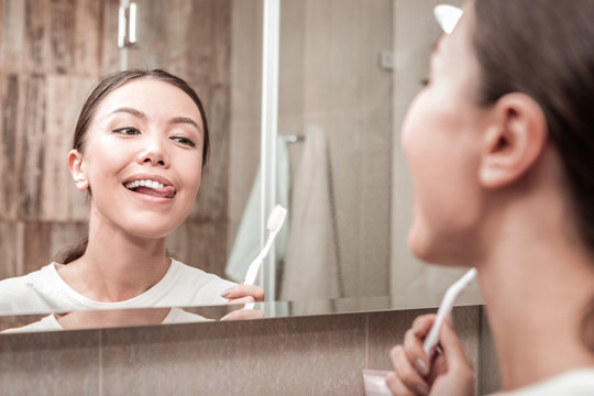 Young Appealing Woman Looking At Her Nice White Teeth