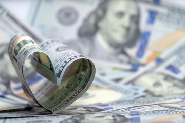 Hundred dollar banknote of usa in the shape of a heart. Money background. Concept financial love and a gift for Valentine's Day. Copy space.