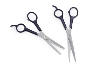 Two different professional hairdressers scissors on a white background