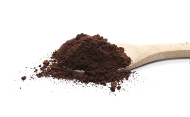 Milled coffee powder with wooden spoon isolated on white background