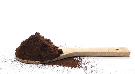 Milled coffee powder with wooden spoon isolated on white background
