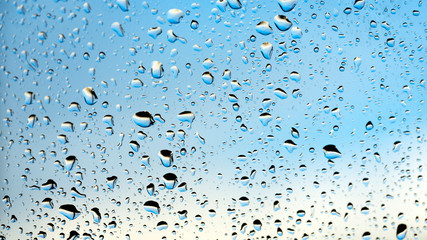 raindrops on glass pane of car window