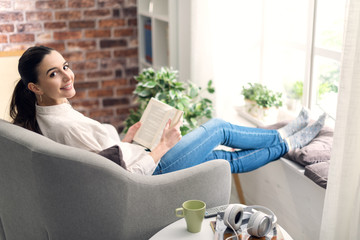 Woman relaxing and reading a book