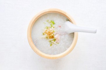 porridge rice with shrimp in wooden bowl. top view photo