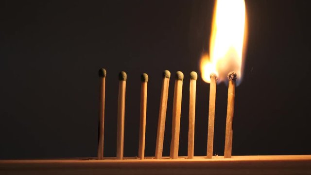 matches sulfur burn with a red flame on a dark background