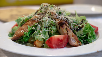 Caesar salad with chicken, cherry tomatoes, lettuce