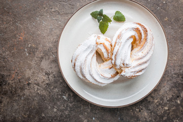 Custard or cottage cheese cakes rings on a white plate, top view