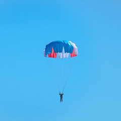 Skydiver flying in blue in sky
