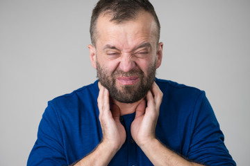 Naklejka premium Man having throat, neck pain