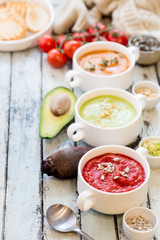 Variety of different colorful vegetable cream soups in a bowls. Concept of healthy eating or vegetarian food.
