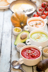 Variety of different colorful vegetable cream soups in a bowls. Concept of healthy eating or vegetarian food.