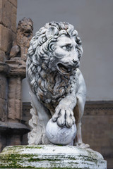 marble sculpture of a lion with a ball at the wall of the cathedral in the Italian city of Florence