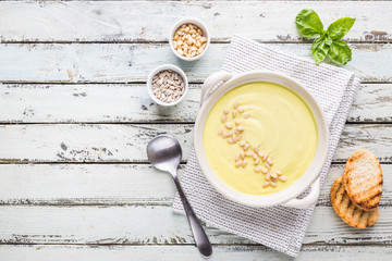 Vegetarian white cauliflower cream soup in a white bowl, top view