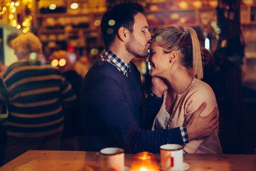 Romantic couple dating in pub at night