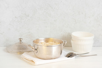 Classical oatmeal porridge on the white table