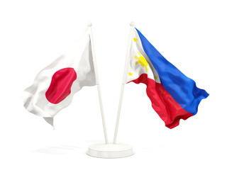 Two waving flags of Japan and philippines
