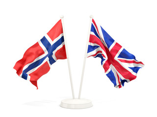 Two waving flags of norway and UK