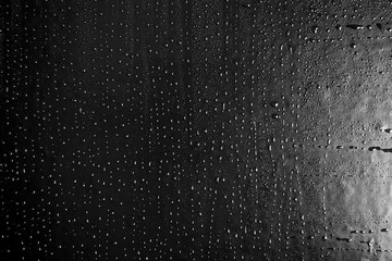Drops of water on a dark glass texture background