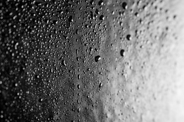 Drops of water on a dark glass texture background