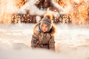 Fototapeta premium boy sitting in the snowdrift