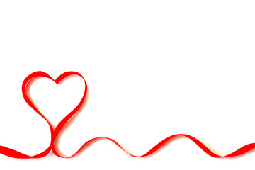 Isolated red satin ribbon in the shape of a heart on a white background with free space. The concept of love and Valentine Day
