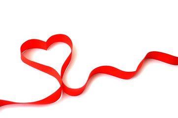 Isolated red satin ribbon in the shape of a heart on a white background with free space. The concept of love and Valentine Day