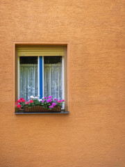 Fototapeta na wymiar Window decorated with Geranium flowers