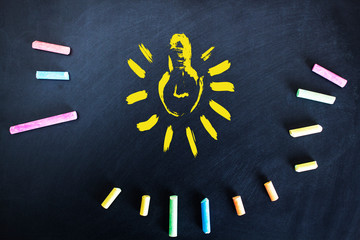 colorful chalk with bulb on board