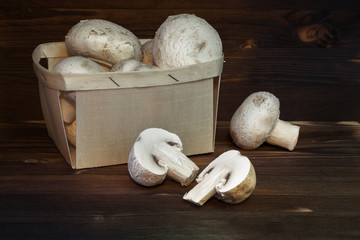 Fresh organic champignons on wooden background