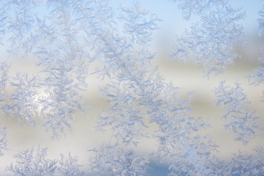 Glitzernde Schneeflocke am Fenster zum Sonnenaufgang