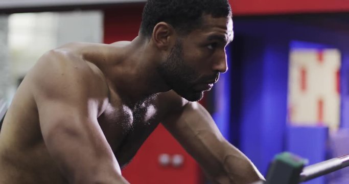 Afro-american male model goes in for sports in the gym.
