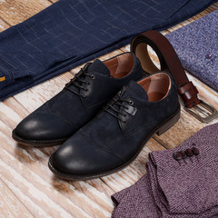 Set of stylish male shoes and clothes on wooden background