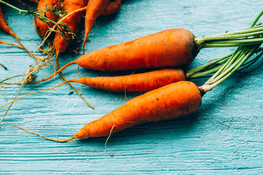 lot of carrots on a wooden background