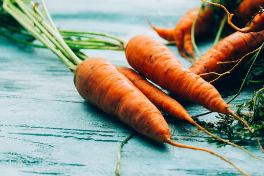 lot of carrots on a wooden background