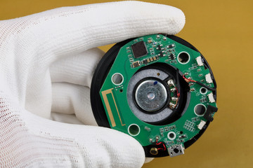 A technician controls the quality of a bluetooth  module for mobile audio device